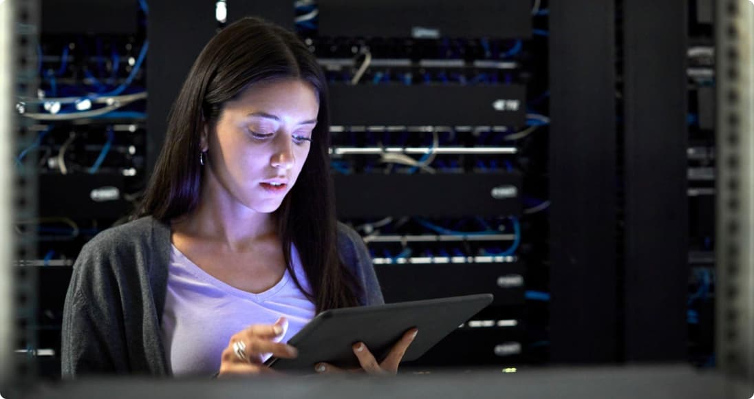 Network operations engineer checking infrastructure in a server room